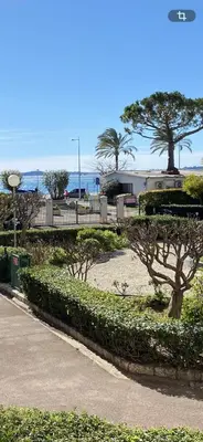 a park with bushes and trees on a beach at Charmant appartement bord de mer, Plage in Cagnes-sur-Mer