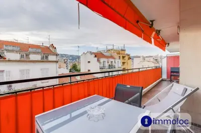 a table on a balcony with a view of the city at Air-conditioned apartment in the Libération district in Nice