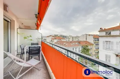 an apartment with a balcony with a desk and a view at Air-conditioned apartment in the Libération district in Nice