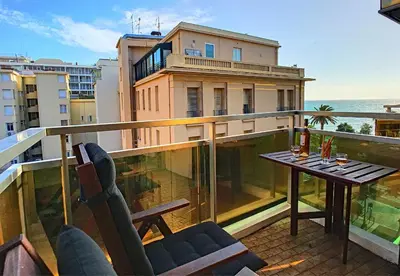 a balcony with a table and chairs on a building at Nestor&Jeeves - STUDIO ROYAL LUXEMBOURG - Central - Swimming pool on roof in Nice