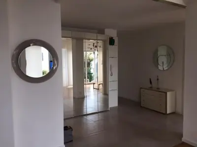 a hallway with a mirror and a dresser in a room at 91 Promenade des Anglais le stellamar in Nice