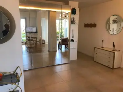 a living room with a mirror and a dresser at 91 Promenade des Anglais le stellamar in Nice