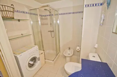 a bathroom with a washing machine and a toilet at PROMENADE HOLIDAY - GRIMALDI CITY CENTER in Nice