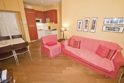 a living room with a pink couch and a table at PROMENADE HOLIDAY - GRIMALDI CITY CENTER in Nice
