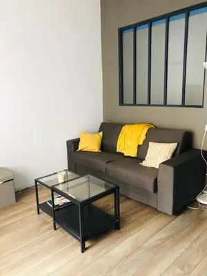 a living room with a couch and a glass table at Appartement NICE proche MER et CENTRE in Nice