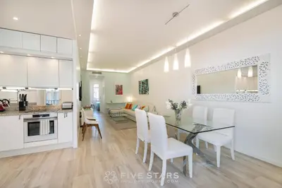 a kitchen and dining room with a table and chairs at Suite Versailles Five Stars Holiday House in Nice