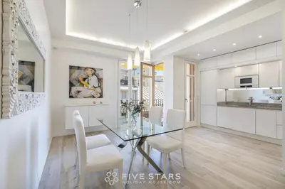 a dining room with a glass table and white chairs at Suite Versailles Five Stars Holiday House in Nice