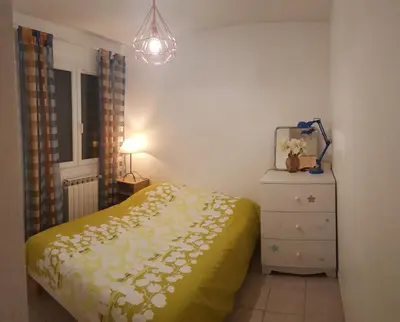 a bedroom with a bed and a dresser and a lamp at Cosy Room in the centre in Saint-Laurent-du-Var