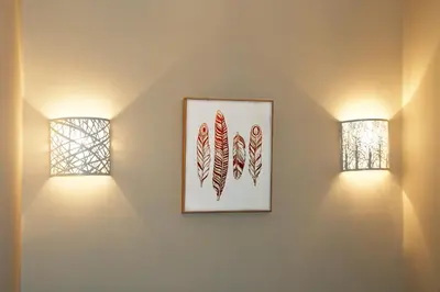 two lights on a wall with two windows at Le jardin du port in Nice