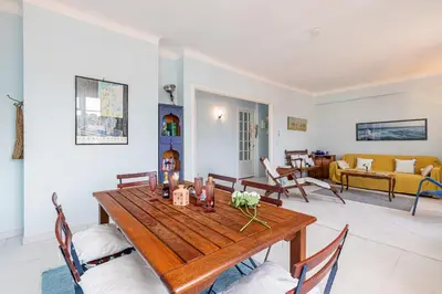 a living room with a wooden table and chairs at Extraordinary View on Port and Castle Hill - 1 Bdr & Parking in Nice