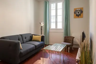 a living room with a couch and a table at Papa Riviera - Nice old town - 1-3 pers in Nice