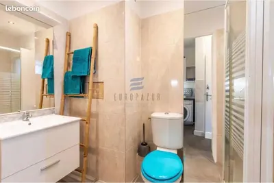 a bathroom with a toilet and a sink and a mirror at Studio Jardin Fleuris Parking in Nice