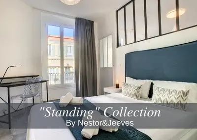 a bedroom with a large bed with a blue headboard at Nestor&Jeeves - BOW WINDOW BUFFA - City center - Very close beach in Nice