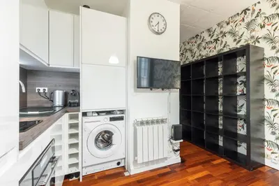 a kitchen with white cabinets and a washer and dryer at Studio en plein cœur de la vieille ville à Nice in Nice