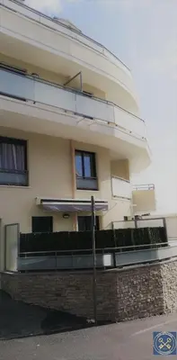 a large white building with a fence in front of it at NICE VIEW Jolie Studio avec Jardin in Nice