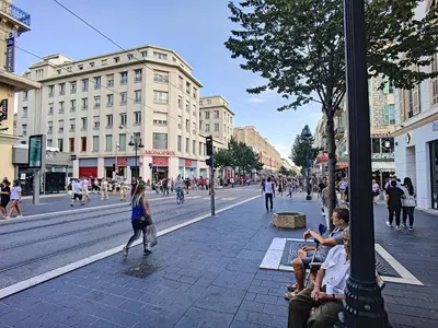 people sitting on a bench on a busy city street at Nestor&Jeeves - MASSENA DREAM - Hyper center - Close sea in Nice