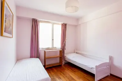 a bedroom with two beds and a window at Le Refuge Acajou - Welkeys in Nice