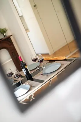 a bathroom mirror with three sinks and wine glasses at 