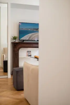 a living room with a tv on top of a fireplace at 