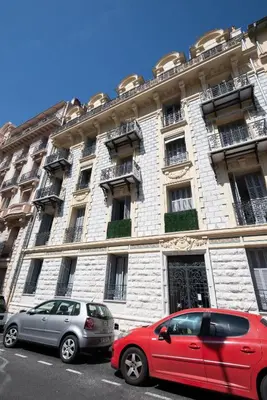 two cars parked in front of a building at 