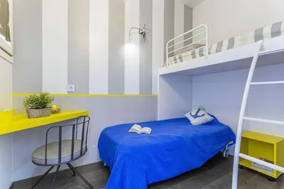 a bedroom with a blue bed and a bunk bed at MY CASA - FLEURS 22 - City Center - Modern w Terrace in Nice