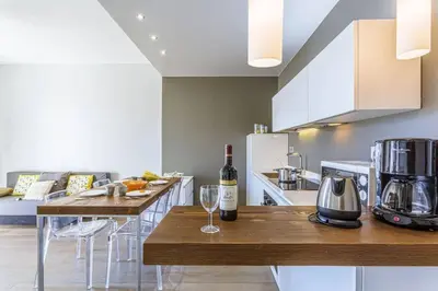 a kitchen with a table with a bottle of wine at MY CASA - FLEURS 22 - City Center - Modern w Terrace in Nice