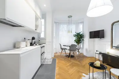 a kitchen and dining room with a table and chairs at HEROLD Balcon in Nice