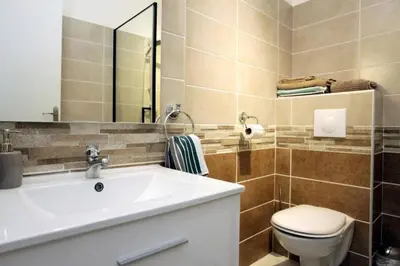a bathroom with a sink and a toilet and a mirror at Studio à Nice ensoleillé proche centre et plage in Nice