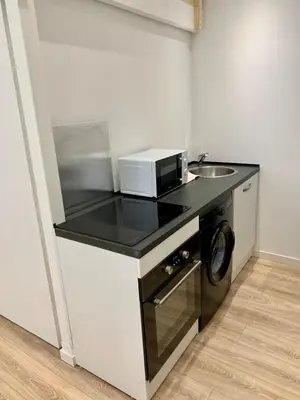 a small kitchen with a sink and a microwave at Gustave 2 in Nice