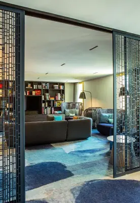 a hotel room with a bed and a chair at Crowne Plaza - Nice - Grand Arenas by IHG in Nice