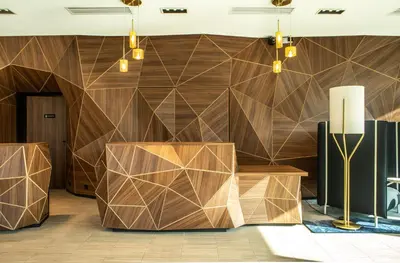 a living room with a couch and chairs and tables at Crowne Plaza - Nice - Grand Arenas by IHG in Nice