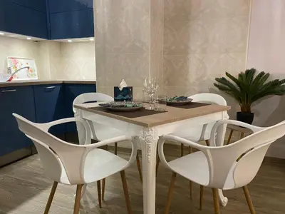 a dining room table with white chairs and a table at Large beautiful studio near the NEGRESCO HOTEL in Nice
