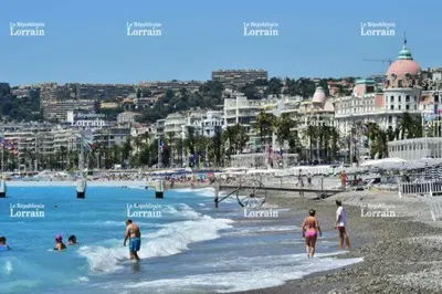 a group of people in the water at a beach at Large beautiful studio near the NEGRESCO HOTEL in Nice