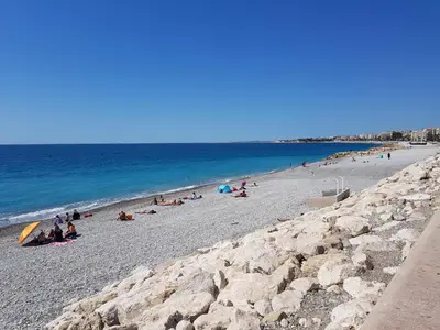 a group of people on a beach near the ocean at NICE - Studio cosy hypercentre à 500m de la plage in Nice