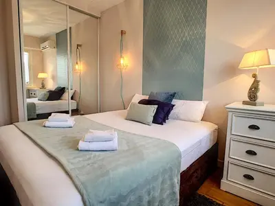 a bedroom with two beds and a mirror at Nestor&Jeeves - CORAL SEA TERRACE - Central - Very close beaches in Nice