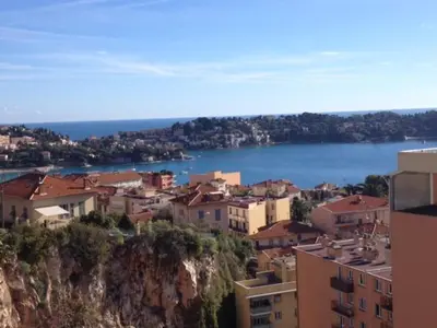 a view of a city and a body of water at Les Lauriers in Villefranche-sur-Mer