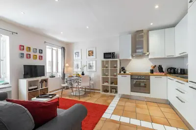 a living room with a couch and a kitchen at 8 CONDAMINE - Stylish in Old Town - 2 pièces - 300m de la mer in Nice