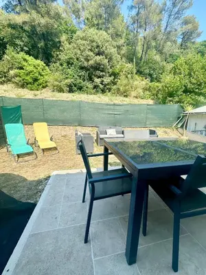 a picnic table and chairs sitting on a patio at Cosy & Chill Appartements - 10 min de la mer - Jardin, Netflix, terrasse, fibre & parking in Cagnes-sur-Mer