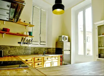 a kitchen with a stainless steel refrigerator and wooden cabinets at Ze Perfect Place - Spacieux appartement - Cours Saleya - 2 CHB - 2 SDB - AC in Nice