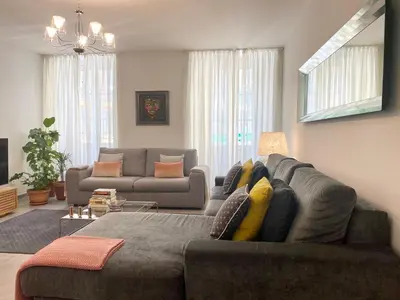 a living room with a gray couch at Cozy 2BR Appartment near the Port of Nice in Nice