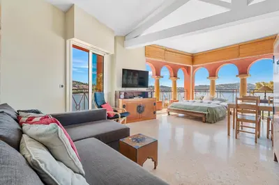 a living room with a couch and a table at Penthouse La Bellevue in Villefranche-sur-Mer