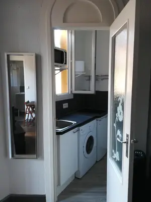 a kitchen with a sink and a washing machine at Charmant studio climatisé centre Villefranche sur mer in Villefranche-sur-Mer