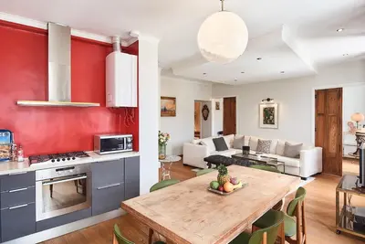 a kitchen and living room with a wooden table at Sunlight Properties - Marinette - Port area, 2 Bedrooms, sleep 6, sea view in Nice