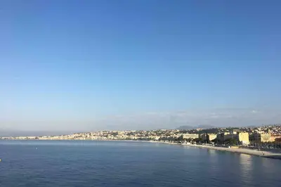 a view of a beach with buildings and the water at CHARMANT HOME-Azur Charmant in Nice