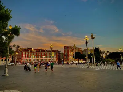 a group of people walking in a plaza with buildings at CHARMANT HOME - Mariesol in Nice