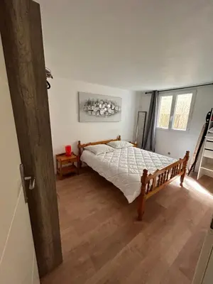 a bedroom with a bed and a wooden floor at T2 RDJ sur la Côte d'Azur tout confort in Cagnes-sur-Mer
