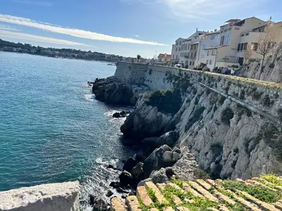 a rocky shoreline with houses and the water at T2 RDJ sur la Côte d'Azur tout confort in Cagnes-sur-Mer