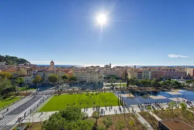a view of a city with the sun in the sky at LE FRANCIA II AP4197 By RIVIERA HOLIDAY HOMES in Nice