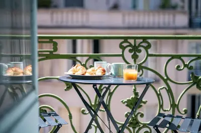 a table with a plate of food and two glasses of orange juice at 