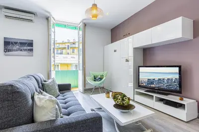 a living room with a couch and a tv at MY CASA - GUISOL - Typical Nice 3 Bedroom AC near Port in Nice